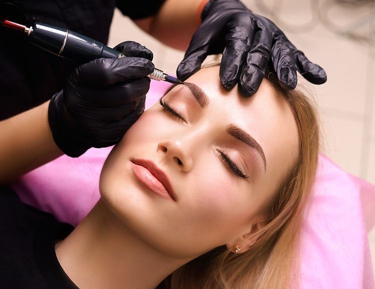 Close-up of a client receiving cosmetic eyebrow treatment