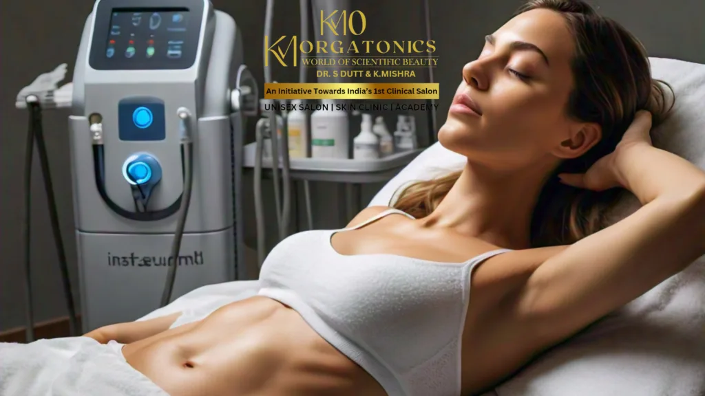 A woman relaxes comfortably on a treatment bed at KM Orgatonics, undergoing a non-surgical InstaSculpt body contouring procedure. The InstaSculpt machine is visible in the background.